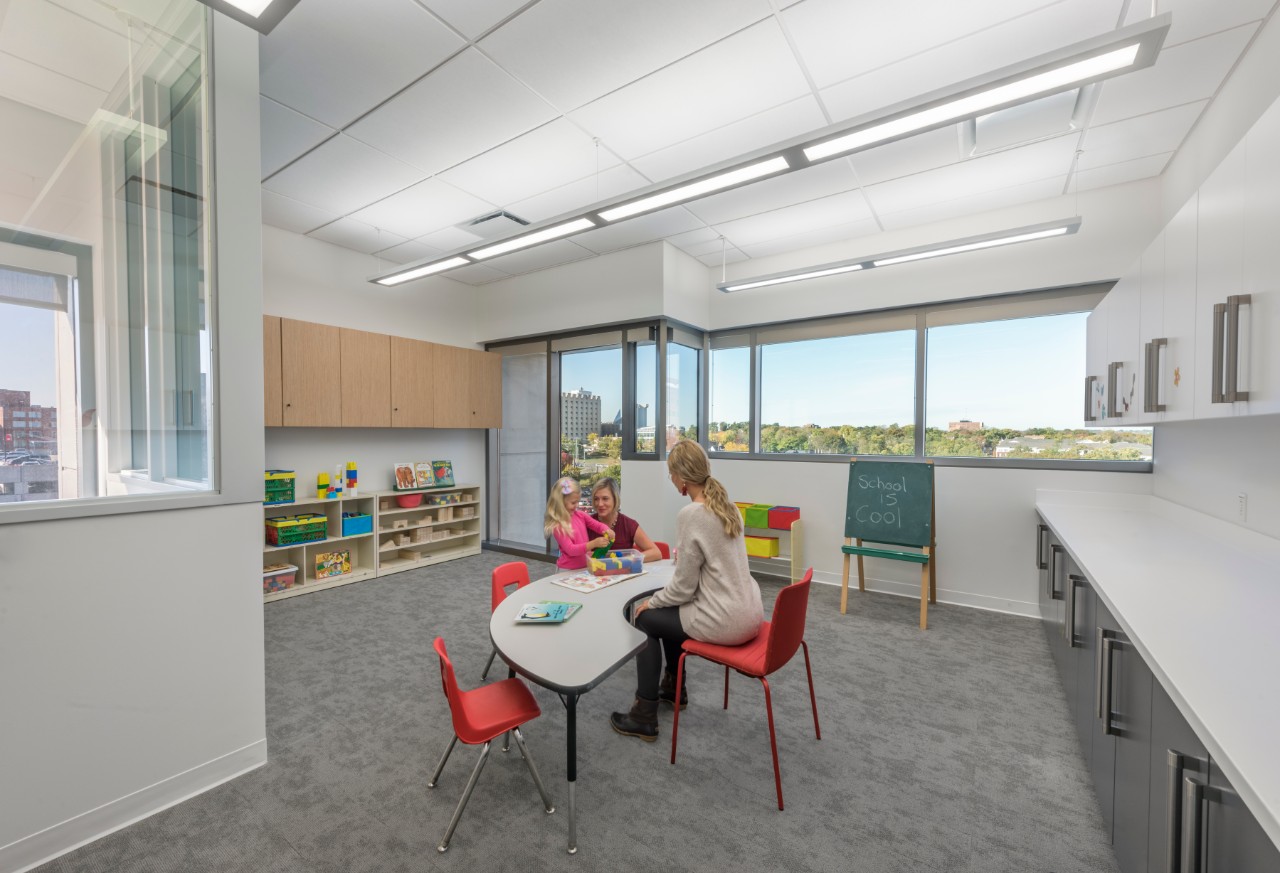 Students and child in the Preschool Room of the Speech and Hearing Clinic