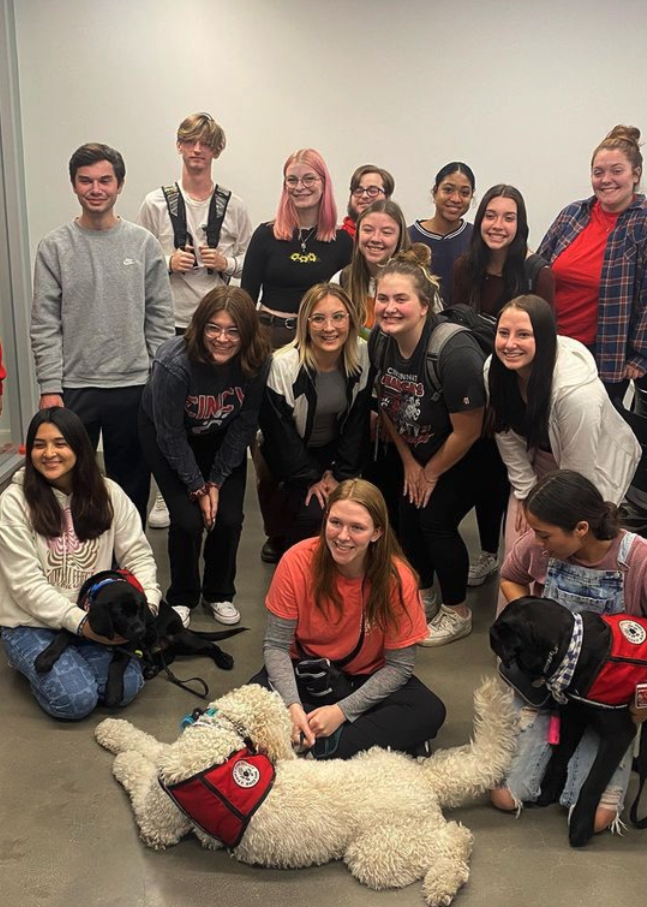 Students pet Sammy, the service dog
